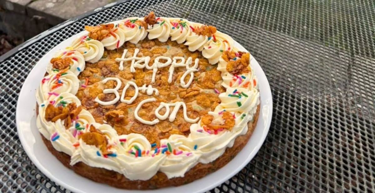 A giant Dunk'd cookie cake topped with cream and sprinkles